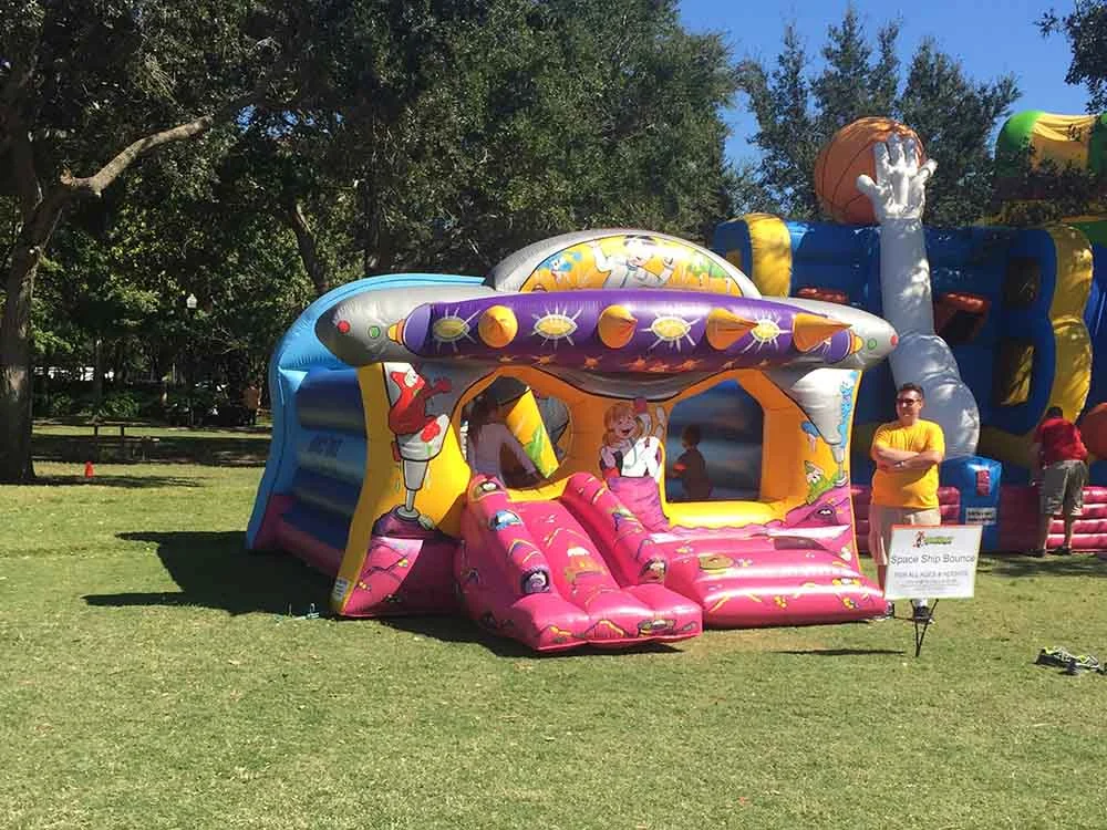 Colorful birthday bounce house rental with slide for a childrens party