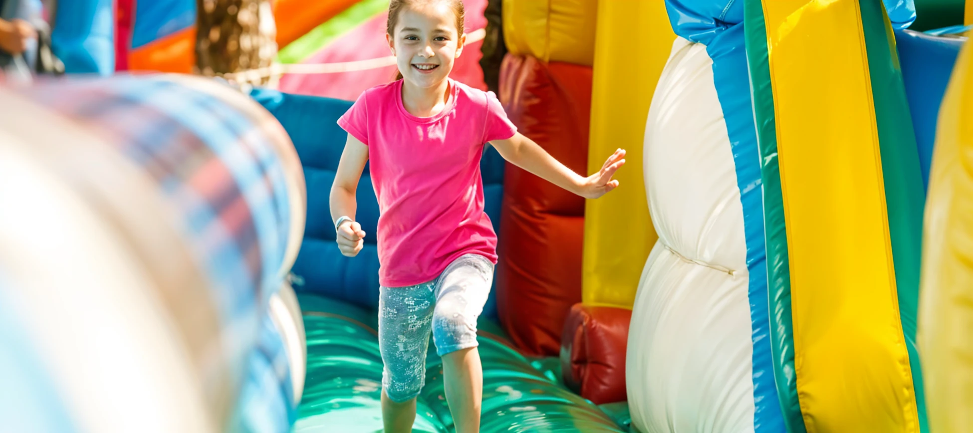 Inflatable obstacle course rental race at an outdoor community event